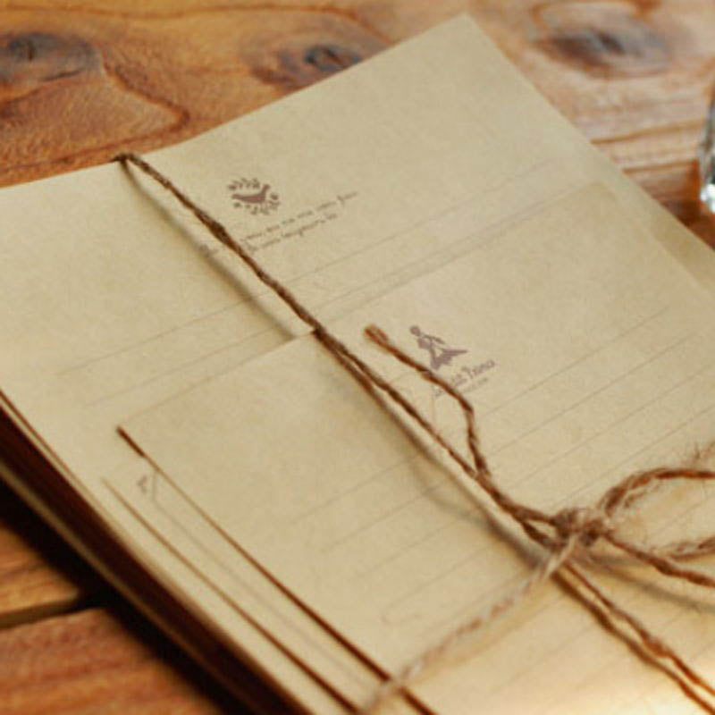 Kraft-colored letter paper with small printed illustrations, a large sheet and a smaller note sheet