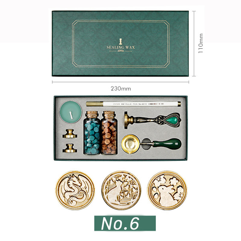 Wax seal kit with dragon, cat and rabbit stamp heads, teal and brown wax beads, spoon and candle in a green box