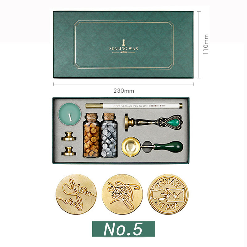 Wax seal kit with Happy Mail, Thank You and With Love stamp heads, amber and silver wax beads in a green box