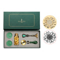 Wax seal set with sunflower stamp, gold wax beads, two tea lights and melting spoon in a green gift box