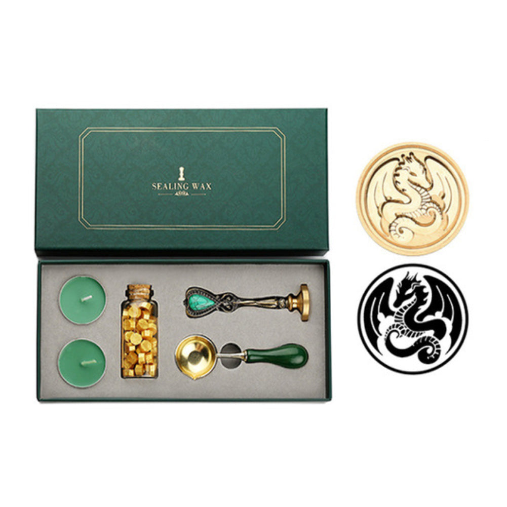 Wax seal set with dragon stamp, gold wax beads, two tea lights and melting spoon in a green gift box