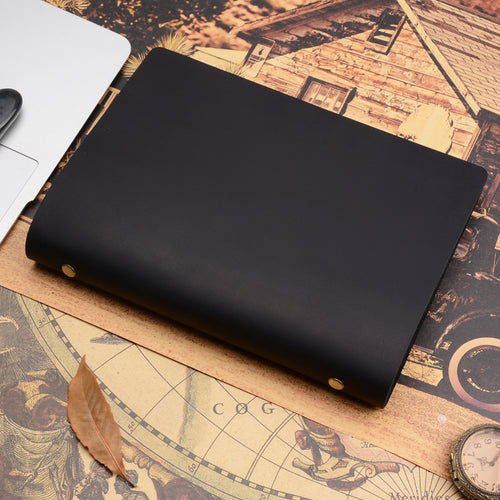 A5 leather ring binder journal in black, closed, on a vintage-style map print