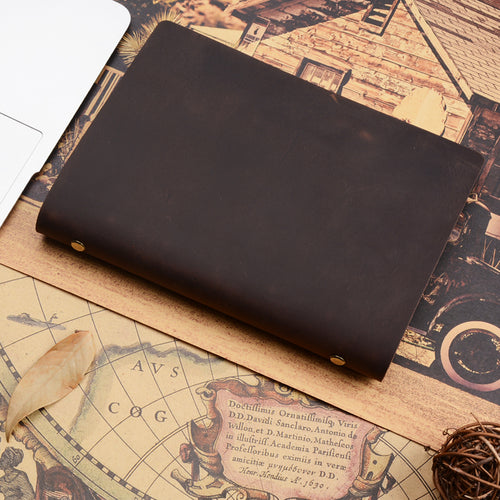 A5 leather ring binder journal in dark brown, closed, on a vintage-style map print
