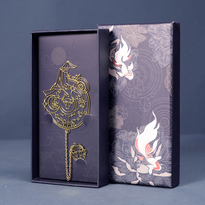 Taurus zodiac bookmark in brass-tone metal with chain and charm in a dark blue gift box