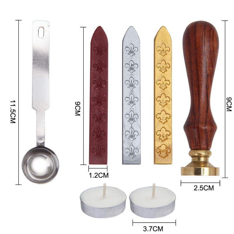 Rose wax seal kit contents with measurements: spoon, three wax sticks, wooden-handled stamp and two tea lights