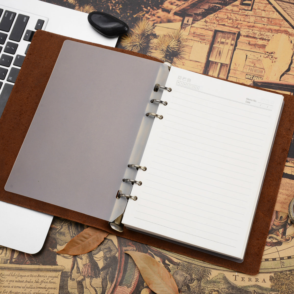 A5 leather binder journal lying open with lined pages and a clear divider